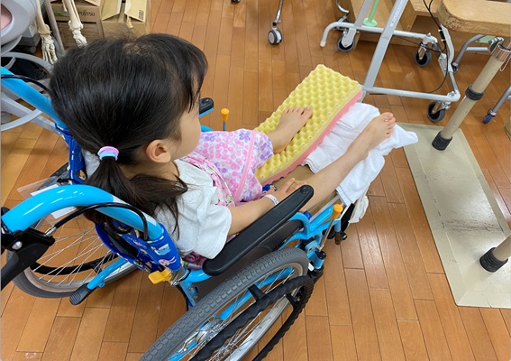 車椅子に乗っている長女、1年弱こちらの器具をつけて、イリザロフ法〈骨を再生する治療法〉をしました