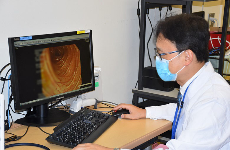 内視鏡で得た大腸内壁の画像で病状を評価する新井医師